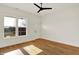 Bright bedroom with hardwood floors, a ceiling fan, and exterior access at 2013 Yandes St, Indianapolis, IN 46202