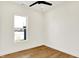Bright bedroom featuring hardwood floors, a ceiling fan, and large window at 2013 Yandes St, Indianapolis, IN 46202