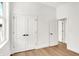 Neutral bedroom featuring light hardwood floors, a large window, and closet space at 2013 Yandes St, Indianapolis, IN 46202
