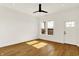 Bright bedroom features hardwood floors, a modern ceiling fan, and a large window at 2013 Yandes St, Indianapolis, IN 46202
