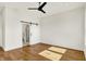 This bedroom features hardwood floors, a fan, and a sliding door to the bathroom at 2013 Yandes St, Indianapolis, IN 46202