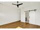 This spacious bedroom features hardwood floors, a fan, and a sliding door to the bathroom at 2013 Yandes St, Indianapolis, IN 46202