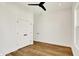 Bright bedroom features hardwood floors, ceiling fan, double door closet, and an additional door at 2013 Yandes St, Indianapolis, IN 46202