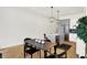 Dining area near a modern kitchen, featuring a black table, stylish chairs, and hardwood floors, with modern light fixtures at 2013 Yandes St, Indianapolis, IN 46202