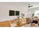 Bright dining area with a glass table, complemented by the adjacent living room's cozy setup and hardwood flooring at 2013 Yandes St, Indianapolis, IN 46202