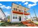 Charming white two-story home with a shared porch and well-manicured lawn at 2013 Yandes St, Indianapolis, IN 46202