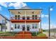 Charming two-story duplex with a vibrant orange staircase and a shared porch at 2013 Yandes St, Indianapolis, IN 46202