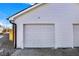 Close-up of a new white garage door shows the concrete driveway and fresh siding at 2013 Yandes St, Indianapolis, IN 46202