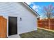 White siding on this detached garage provides a clean backdrop to a small fenced yard at 2013 Yandes St, Indianapolis, IN 46202