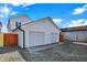 Exterior shot of two-car garage shows fresh white siding and doors with gravel driveway at 2013 Yandes St, Indianapolis, IN 46202