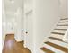 Bright hallway with hardwood floors, white walls and trim, and a staircase at 2013 Yandes St, Indianapolis, IN 46202