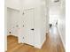 Hallway featuring hardwood floors, white walls, and a view of the living area at 2013 Yandes St, Indianapolis, IN 46202