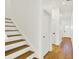 Bright hallway features hardwood floors, neutral walls, and stairs leading to the upper level at 2013 Yandes St, Indianapolis, IN 46202