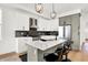 Modern kitchen with stainless appliances, an island with bar seating, and gray and white cabinetry at 2013 Yandes St, Indianapolis, IN 46202