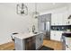 Modern kitchen features stainless steel appliances, island with a sink, and stylish lighting at 2013 Yandes St, Indianapolis, IN 46202
