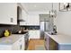 Modern kitchen featuring white cabinets, stainless steel appliances, quartz countertops, and gas range at 2013 Yandes St, Indianapolis, IN 46202