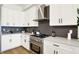 Well-equipped kitchen features stainless steel appliances, modern cabinetry, and designer backsplash at 2013 Yandes St, Indianapolis, IN 46202