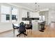 Eat-in kitchen with a large island, stainless appliances, light wood floors, and a modern design at 2013 Yandes St, Indianapolis, IN 46202