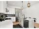 Modern kitchen with white cabinets, stainless steel appliances, and a kitchen island at 2013 Yandes St, Indianapolis, IN 46202