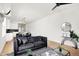 Spacious living room with hardwood floors, a modern sofa, and an open kitchen at 2013 Yandes St, Indianapolis, IN 46202