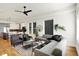 Open-concept living room with hardwood floors, modern furniture, and a view into the kitchen and dining area at 2013 Yandes St, Indianapolis, IN 46202