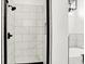 Modern shower with marble tile, a black shower head, and glass door at 2013 Yandes St, Indianapolis, IN 46202