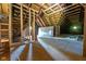 Unfinished attic featuring wooden framing and flooring, offering potential for customization and expansion at 207 S Center St, Plainfield, IN 46168