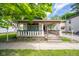 Inviting porch features classic columns, offering a relaxing outdoor space at 207 S Center St, Plainfield, IN 46168