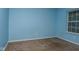 A bright bedroom with a blue painted walls and a window allowing natural light at 2416 Foxtail Dr, Plainfield, IN 46168