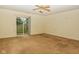 Bedroom with neutral carpeting, a ceiling fan, and a sliding glass door leading to the backyard at 2416 Foxtail Dr, Plainfield, IN 46168