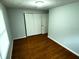Bedroom featuring hardwood floors, a window, and sliding closet doors at 2435 Asbury St, Indianapolis, IN 46203
