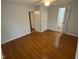 Bedroom features hardwood floors, ceiling fan, and multiple doors for easy access at 2435 Asbury St, Indianapolis, IN 46203