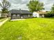 Lush front yard of the one-story home on a cloudy day at 2435 Asbury St, Indianapolis, IN 46203