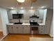 Modern kitchen with stainless steel oven and microwave with hardwood floor at 2435 Asbury St, Indianapolis, IN 46203