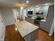 Updated kitchen with island, stainless steel appliances, gray cabinets, and hardwood floors at 2435 Asbury St, Indianapolis, IN 46203