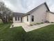 Spacious backyard featuring a concrete patio, grassy lawn, and partial view of the home's exterior at 2635 Red Admiral Ln, Lebanon, IN 46052
