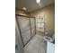 Modern bathroom features a frosted glass shower, tile flooring, and updated fixtures at 2635 Red Admiral Ln, Lebanon, IN 46052