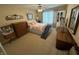 Bright bedroom showcases a comfortable queen-sized bed, natural light, and plush carpet flooring at 2635 Red Admiral Ln, Lebanon, IN 46052