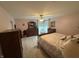 Inviting bedroom features plush carpeting, a ceiling fan, and classic wooden furniture at 2635 Red Admiral Ln, Lebanon, IN 46052