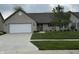 Charming single-story home featuring a well-manicured lawn, brick facade, and a two-car garage at 2635 Red Admiral Ln, Lebanon, IN 46052