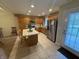 Bright kitchen with stainless steel refrigerator, center island, tile floors, and natural wood cabinets at 2635 Red Admiral Ln, Lebanon, IN 46052