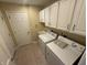Functional laundry room featuring a washer, dryer, and storage cabinets for optimal convenience at 2635 Red Admiral Ln, Lebanon, IN 46052
