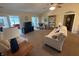 Bright living room with vaulted ceilings, plush carpeting, and French doors leading to the outdoors at 2635 Red Admiral Ln, Lebanon, IN 46052