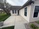 Back patio with sliding doors leading into the home and a view of the green lawn and landscape at 2635 Red Admiral Ln, Lebanon, IN 46052