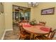 Dining room with wood table and access to an enclosed sunroom at 270 Rapid Rill Ln, Brownsburg, IN 46112