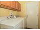 Laundry room featuring a washer and dryer with laminate flooring and a door at 270 Rapid Rill Ln, Brownsburg, IN 46112