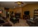 Open living room with fireplace, ceiling fan, comfortable seating, and neutral carpet at 270 Rapid Rill Ln, Brownsburg, IN 46112