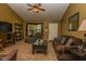 Cozy living room with brown sofa, coffee table, ceiling fan, and large front window at 270 Rapid Rill Ln, Brownsburg, IN 46112
