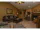 Well-lit living room featuring a fireplace, plush seating, and neutral-toned carpet at 270 Rapid Rill Ln, Brownsburg, IN 46112