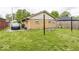 Wide backyard with brick exterior and partial privacy fence at 3510 E 34Th St, Indianapolis, IN 46218